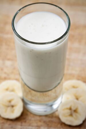 Glass with banana milk and banana slices.の写真素材