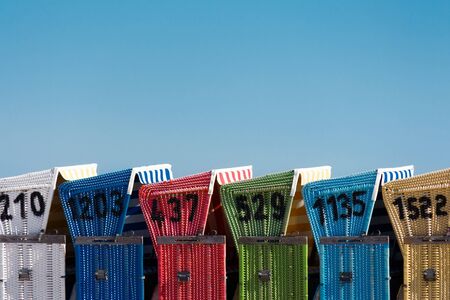 Close-up image of beach chairs with blue sky の写真素材