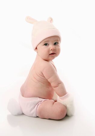 Cute baby girl wearing bunny rabbit ears and tail Easter costume, isolated on whiteの写真素材