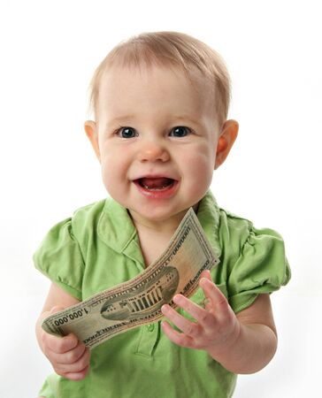 Cute baby girl smiling holding on to a million dollar bill  moneyの写真素材