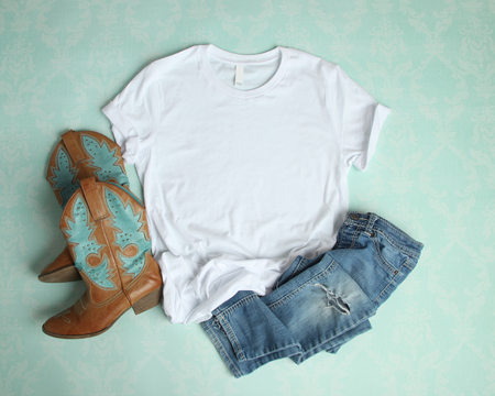 Flat Lay mockup of white t shirt on aqua background with cowboy boots and ripped jeansの写真素材
