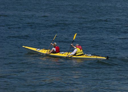 Couple kayaking on lakeの写真素材