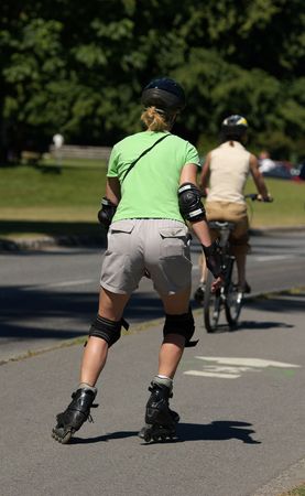 young women rollerblading through Stanley park in Vancouver BCの写真素材
