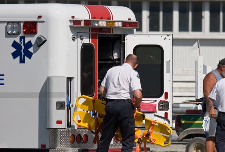 Paramedic unloading back board at accidentの写真素材