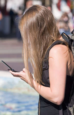 young woman dialing cellphoneの写真素材