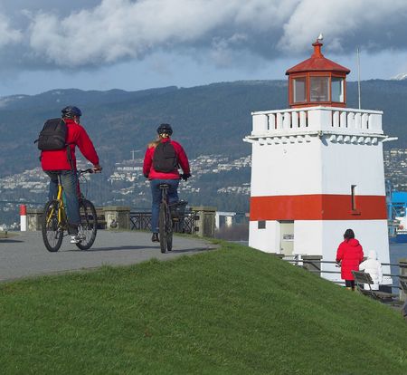 cyclists on the Stanley park seawallの写真素材