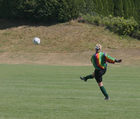 goalie kicking soccer ball in womens recreational leagueの写真素材