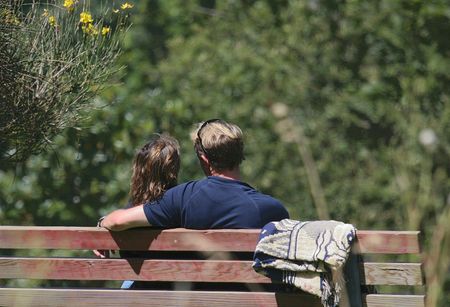 couple enjoying some time on a park benchの写真素材