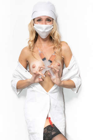 Sexy nurse with syringe in hands, erotic game, quest with honey sister, cosplay doctorの写真素材