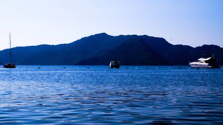 Landscape of sea and mountains with 3 boats.の写真素材