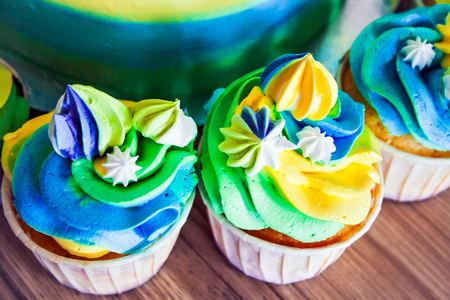 Colorful bright cupcakes closeup on the table.の写真素材