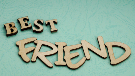 Message best friend of wooden blocks on a mint color background.の写真素材