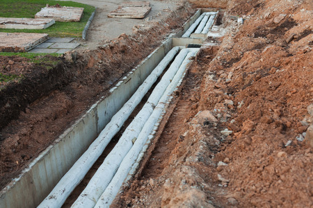 Old, Soviet time water pipelines after excavation, damaged asbestos coatingの写真素材