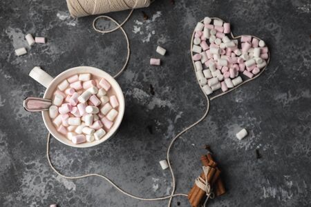 A cup of hot cocoa with white cotton yarn heart for Saint Valentines day full of marshmallowsの写真素材