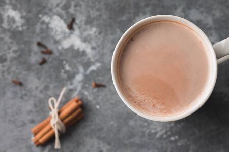 A white cup of hot cocoa drink with cinnamonの写真素材