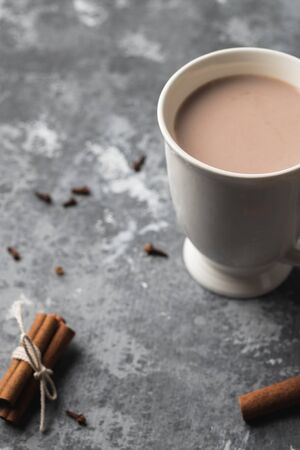 A white cup of hot cocoa drink with cinnamonの写真素材
