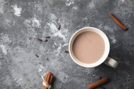 A white cup of hot cocoa drink with cinnamonの写真素材