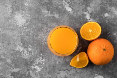 A freshly squeezed orange juice in a clear glass with a copy spaceの写真素材