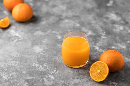 A freshly squeezed orange juice in a clear glass with a copy spaceの写真素材