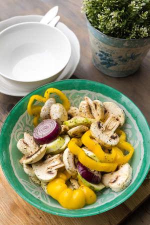A bowl of marinated vegetables prepped for outdoor grilling. Dinner party for friends.の写真素材