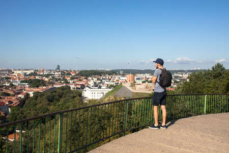 A young caucasian man traveling in Northern Europe with black camera backpackの写真素材
