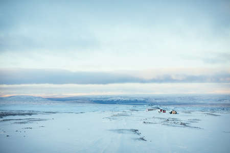 Farmhouse and adjacent buildings standing solitary during winter, rural area, isolatedの写真素材