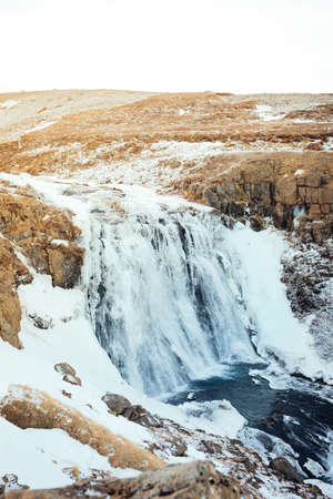 Winter landscape over a waterfall in Iceland, not far from LangjÃ¶kull glacier in Icelandの写真素材