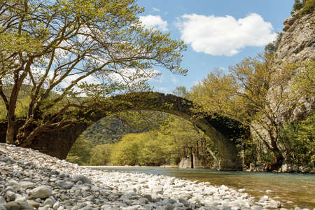 Kleidonia stone bridge over river Aoos or Vjose in Vikos National park, northwestern Greece, Europeの写真素材