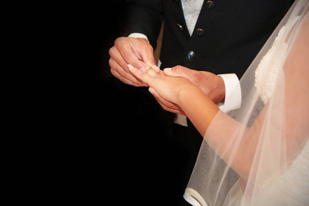 A couple of young romance and love they exchange rings on black background,の写真素材