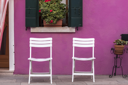 Chairs on a street in Burano, Italyの写真素材