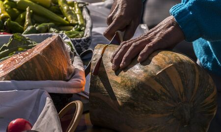 Cutting pumpkin in a street store in old Madrid. In the area of Madrid de los Austriasの写真素材