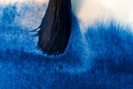 painting with the brush a watercolor blue abstract backgroundの写真素材