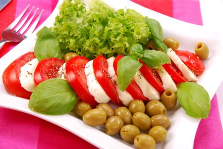 caprese salad with mozzarella,tomato and olivesの写真素材