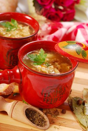 traditional polish tripe soup with vegetables in red ramekinの写真素材