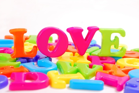 love -word arranged of colorful plastic letters isolated on whiteの写真素材