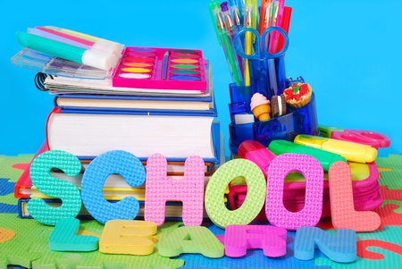 colorful school equipment against blue background