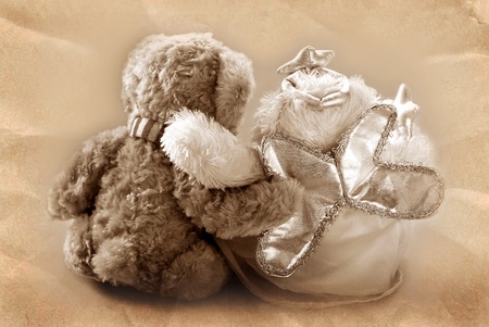 vintage teddy bear`s couple sitting with backand embracing  in sepiaの写真素材