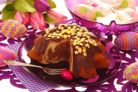 marble ring cake poured chocolate with star shape topping on easter table in purple color