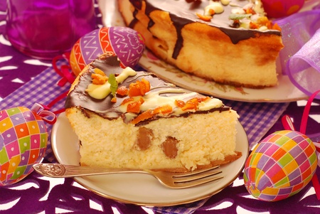 portion of homemade cheese cake with raisins and candied orange peel poured chocolate for easter