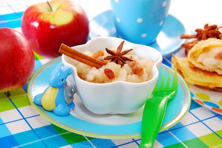 bowl of homemade apple puree with raisins as dessert for babyの写真素材