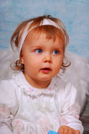 little baby girl with white wings as angelの写真素材