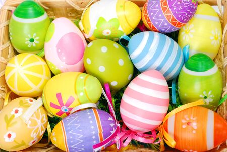 colorful background with easter painted eggs in wicker basket