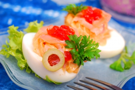 eggs stuffed with smoked salmon and red caviar as appetizerの写真素材