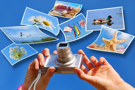  hands taking photos by digital camera against blue sky with summer holidays conceptの写真素材