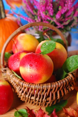 fresh red apples with water drops in wicker basketの写真素材