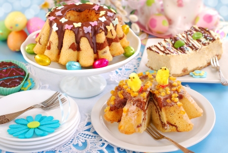 easter confectionery assortment with  marble ring cakes and cheesecake on festive tableの写真素材
