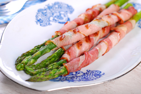 grilled green asparagus wrapped in bacon slices の写真素材