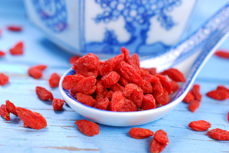 closeup of healthy dried goji berries on chinese porcelain spoonの写真素材