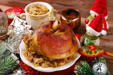 roasted pork knuckle served with bigos (sauerkraut ) for christmas dinnerの写真素材