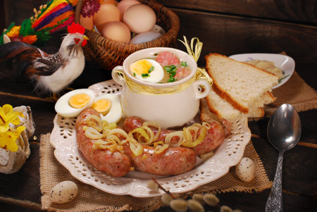 easter white borscht with eggs and roasted sausage on rural wooden backgroundの写真素材
